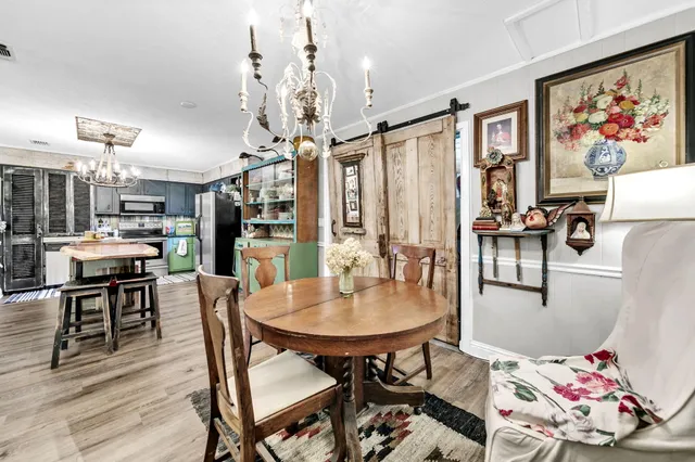 a view of a dining room with furniture and chandelier