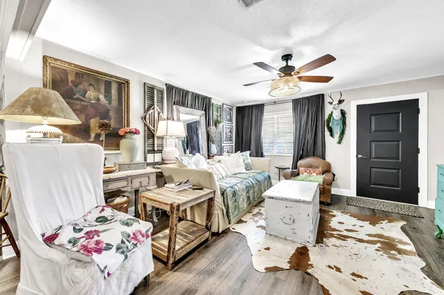 a living room with furniture and a wooden floor