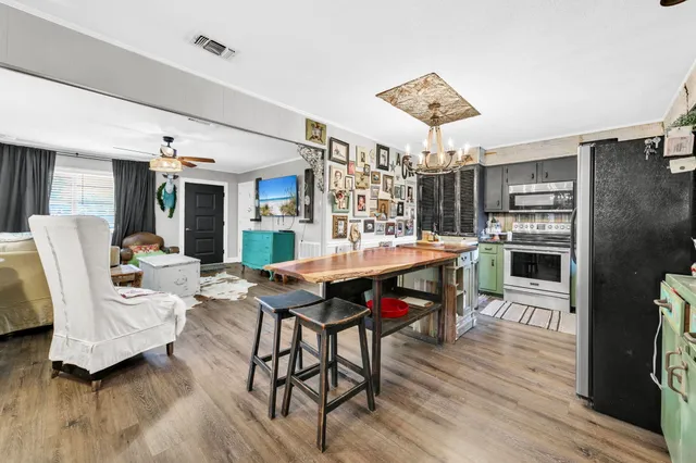 a view of a dining room with furniture and wooden floor