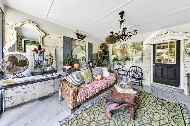 a living room with furniture a chandelier and a window