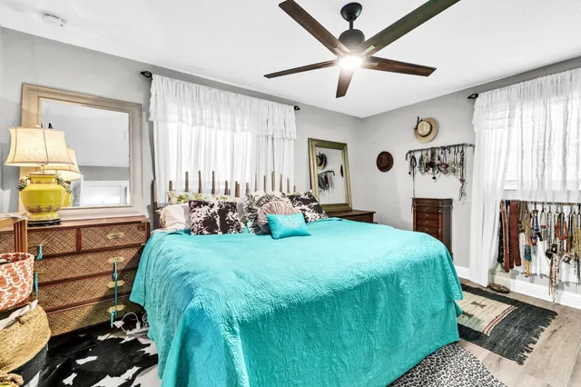 a bed room with a bed window and a chandelier