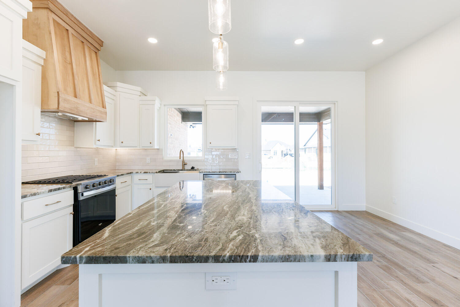 3634 144th Street Lubbock, TX 79423 - Photo 20 of 55 a kitchen with kitchen island granite countertop a stove and a sink