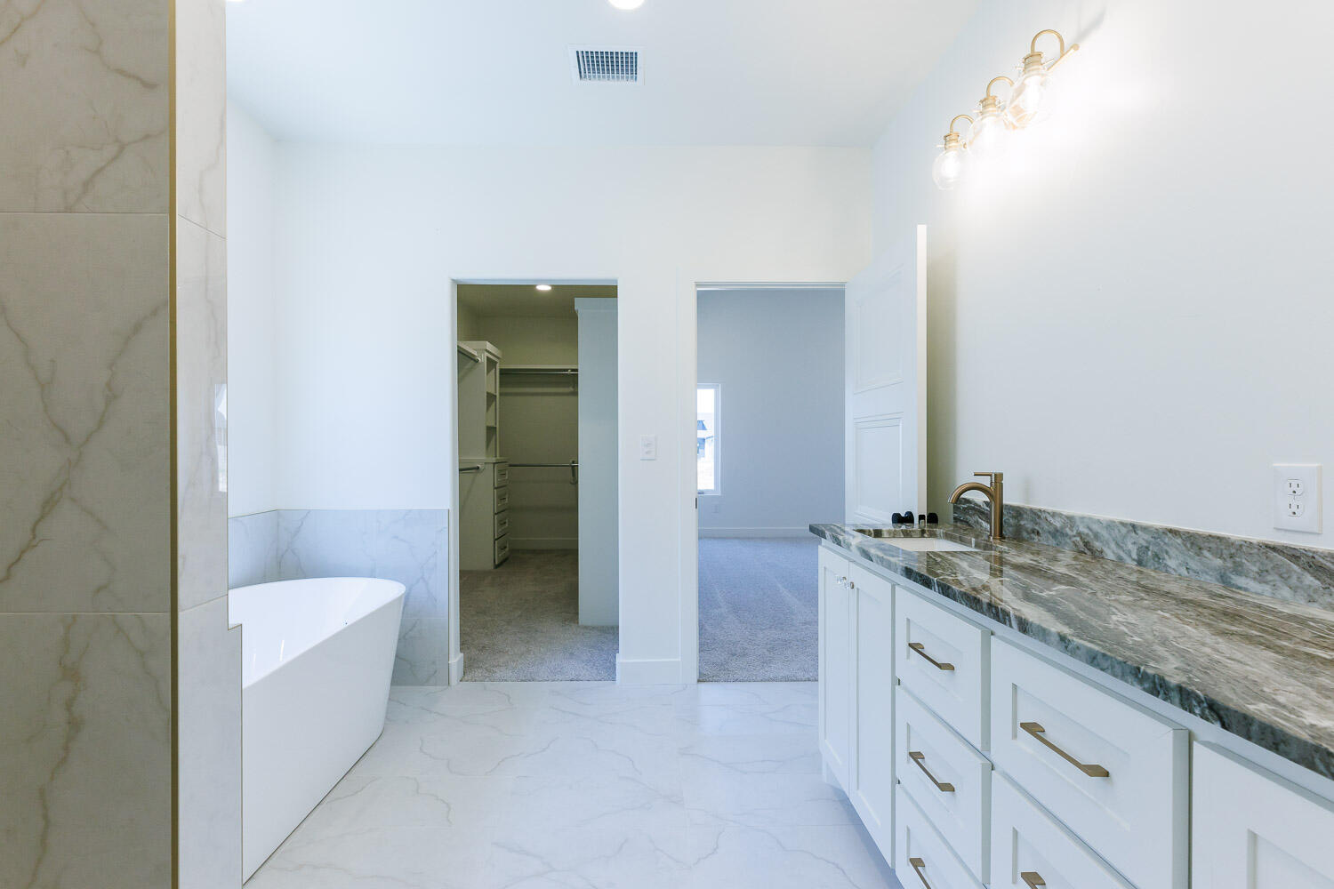 3634 144th Street Lubbock, TX 79423 - Photo 32 of 55 a bathroom with a granite countertop sink and bathtub