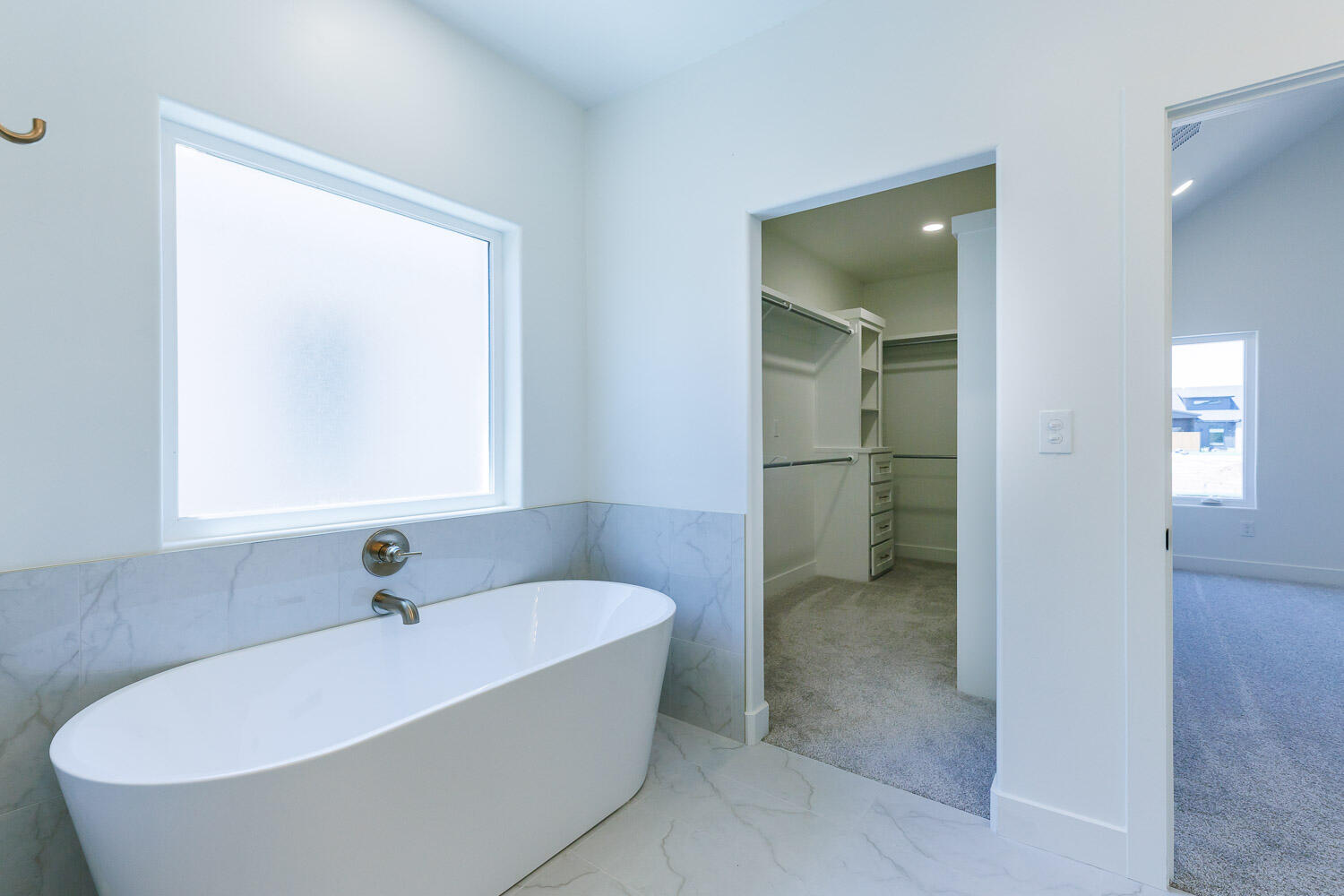 3634 144th Street Lubbock, TX 79423 - Photo 35 of 55 a white bath tub sitting in a bathroom