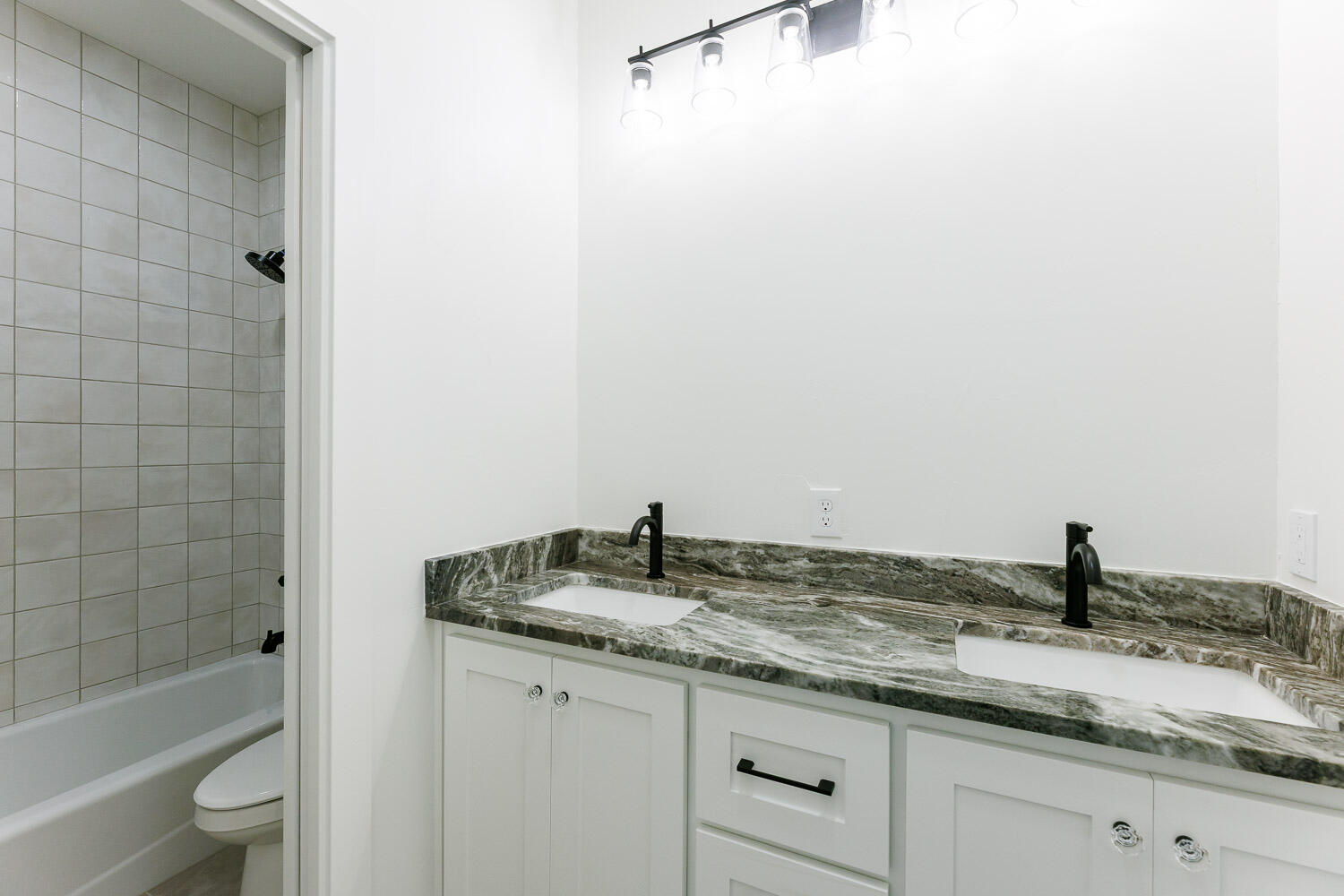 3634 144th Street Lubbock, TX 79423 - Photo 40 of 55 a bathroom with a granite countertop sink toilet and shower