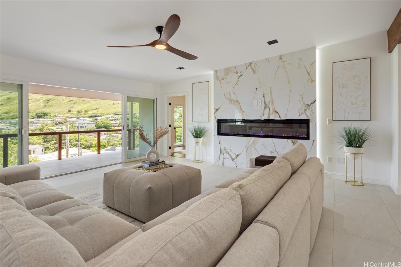 852 Kainoa Place Honolulu, HI 96821 - Photo 8 of 25 a living room with furniture a large window and a fireplace