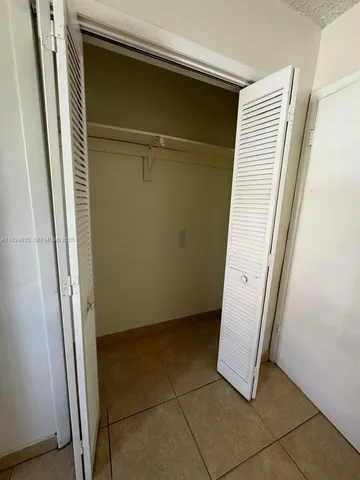 a view of a porch with furniture and a yard