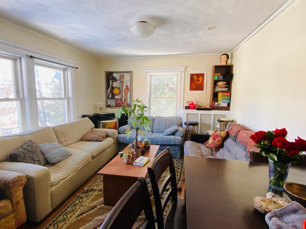 11 Kinross Road, Unit 2 Boston, MA 02135 - Photo 1 of 1 a living room with furniture and flowers