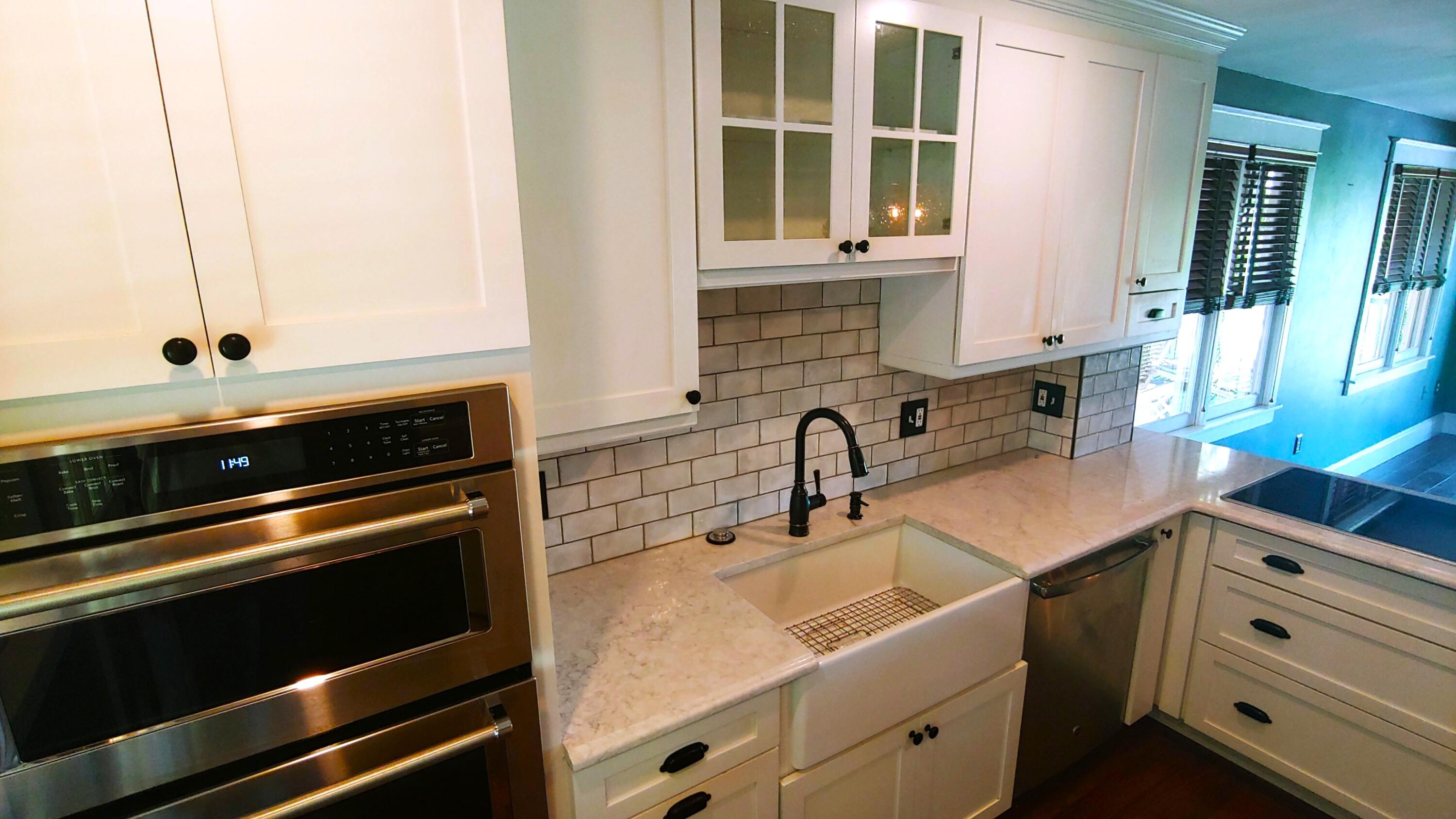 22 Merganser Lane Key West, FL 33040 - Photo 20 of 46 a kitchen with granite countertop a sink stove and cabinets