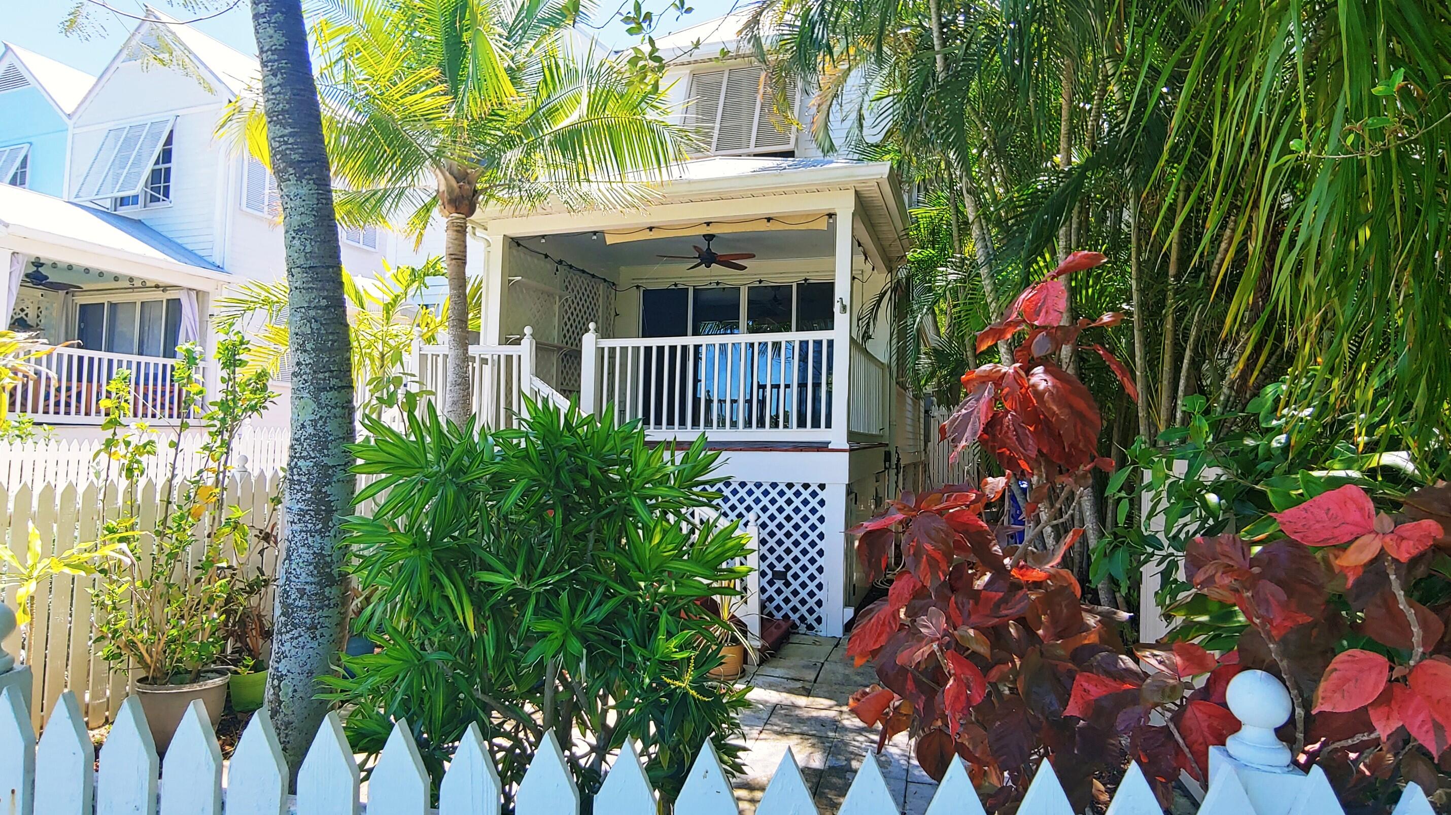 22 Merganser Lane Key West, FL 33040 - Photo 10 of 46 a front view of a house with a flower garden