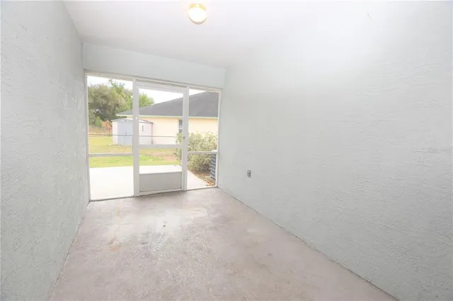 a view of an empty room and a window