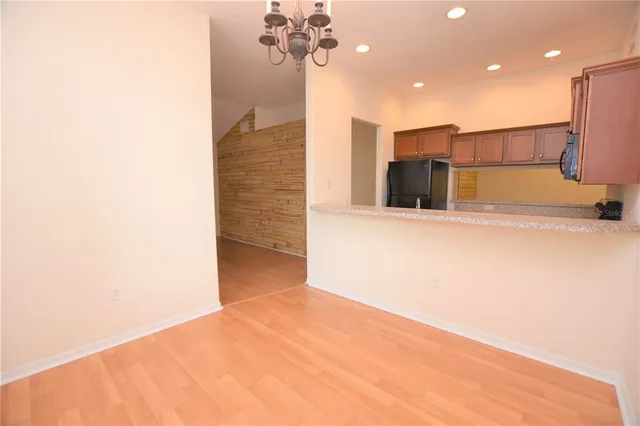 a view of a kitchen with a refrigerator and a ceiling fan