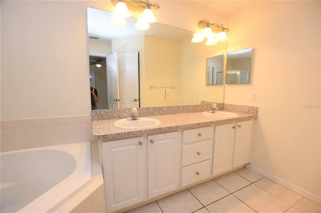 a bathroom with a granite countertop sink mirror and