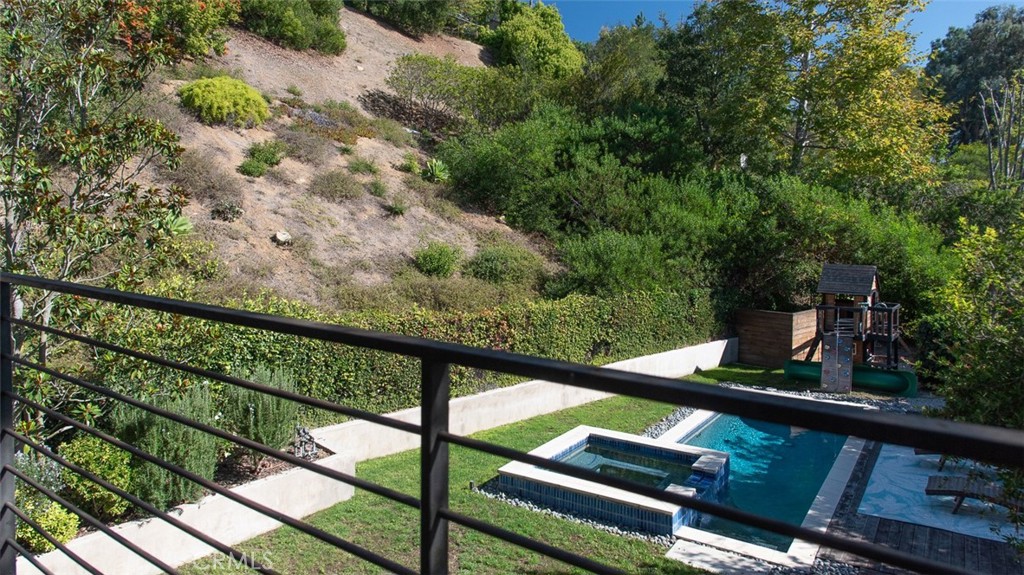 13501 Bayliss Road Brentwood, CA 90049 - Photo 13 of 24 a view of a balcony with wooden floor and fence