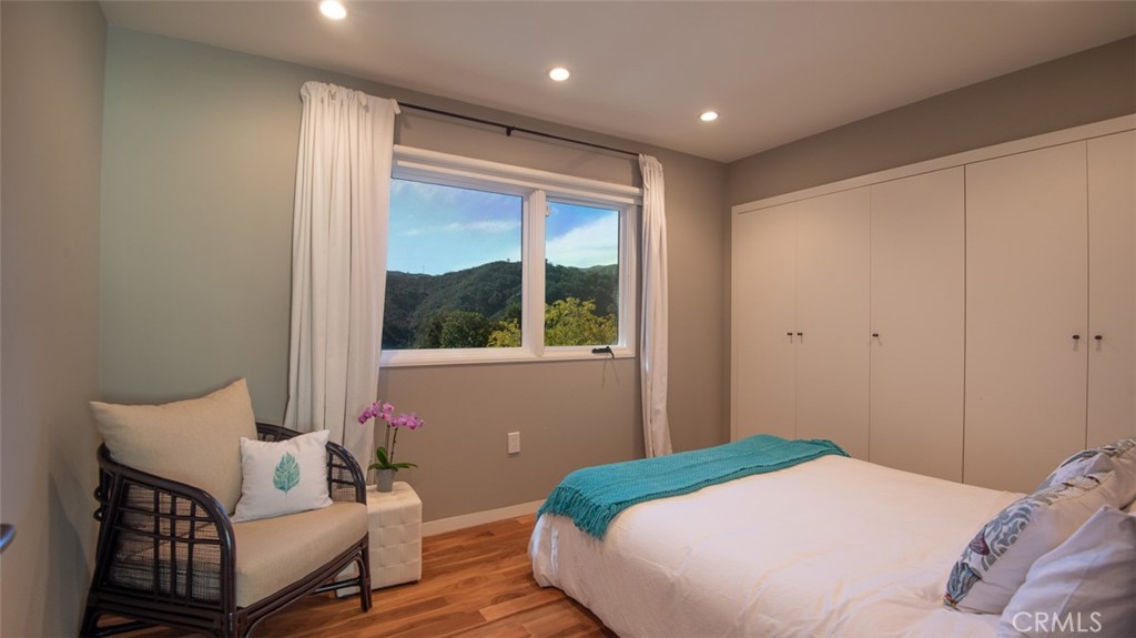 13501 Bayliss Road Brentwood, CA 90049 - Photo 15 of 24 a bedroom with a bed and wooden floor