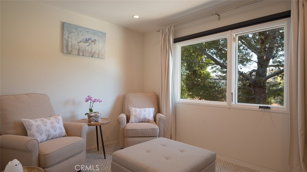 13501 Bayliss Road Brentwood, CA 90049 - Photo 16 of 24 a living room with furniture and a window