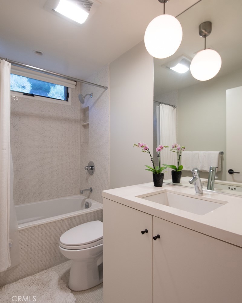 13501 Bayliss Road Brentwood, CA 90049 - Photo 18 of 24 a bathroom with a sink a toilet and shower