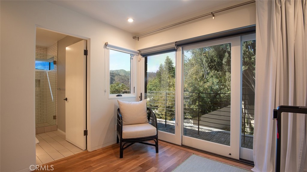 13501 Bayliss Road Brentwood, CA 90049 - Photo 21 of 24 a room with wooden floor and glass door