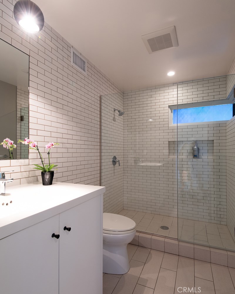 13501 Bayliss Road Brentwood, CA 90049 - Photo 22 of 24 a bathroom with a sink a toilet and shower