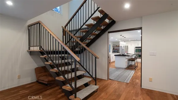 a view of entryway and hall with wooden floor