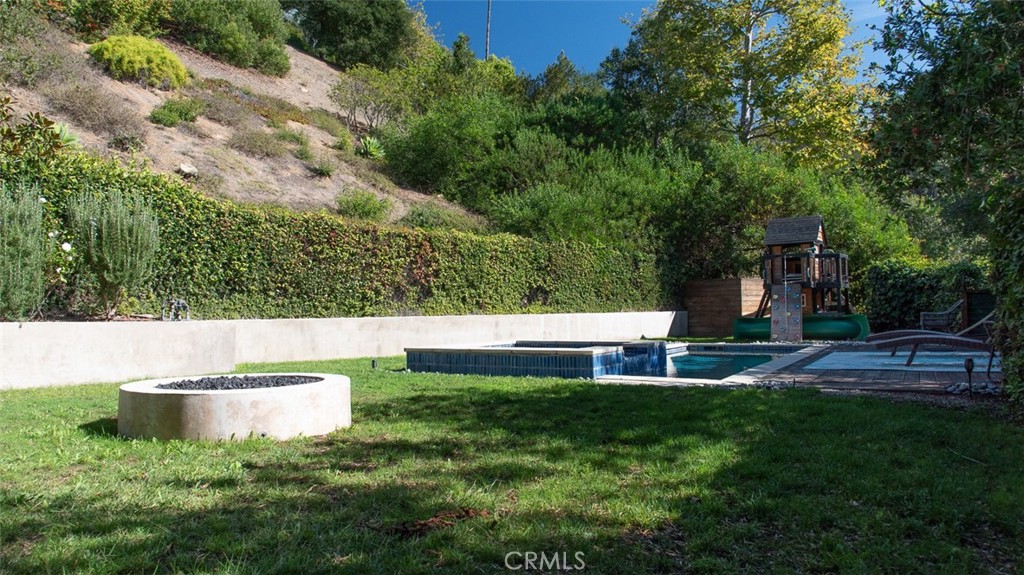 13501 Bayliss Road Brentwood, CA 90049 - Photo 5 of 24 a view of a house with a yard