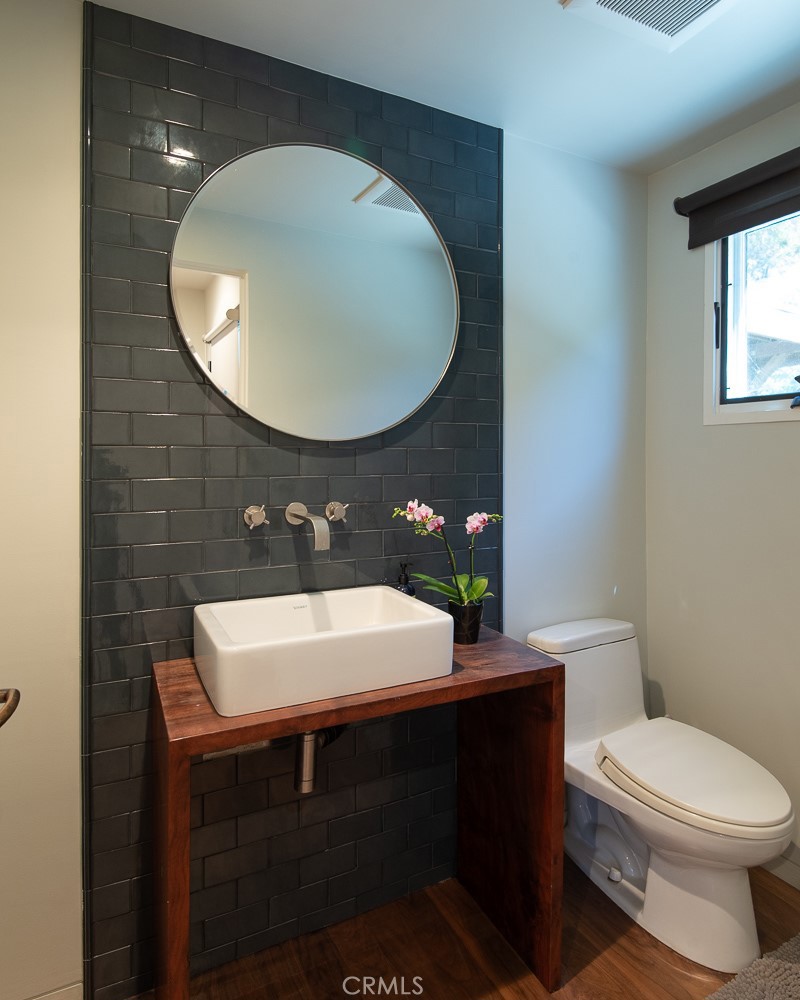 13501 Bayliss Road Brentwood, CA 90049 - Photo 7 of 24 a bathroom with a sink toilet and a mirror