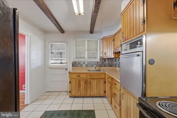 a kitchen with stainless steel appliances a refrigerator sink and cabinets