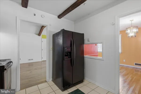 an empty room with window and wooden floor