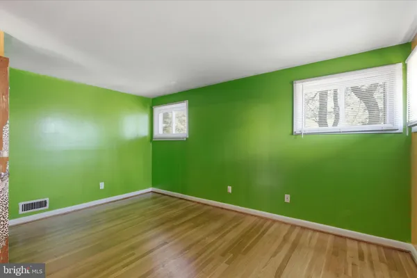 a view of a room with wooden floor and entryway