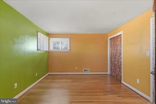 a view of room with window and wooden floor