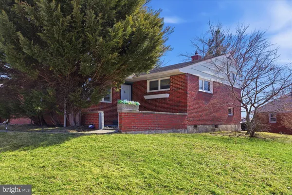 a front view of brick house with a yard