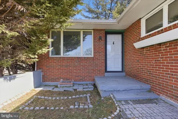 a view of a brick house with a door and wooden floor