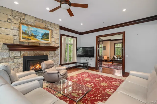 a kitchen with a stove a refrigerator and a dining table with wooden floor