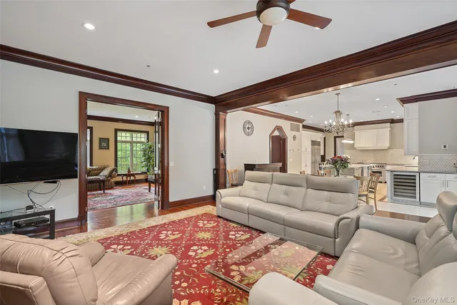 a dining room with furniture a chandelier and wooden floor