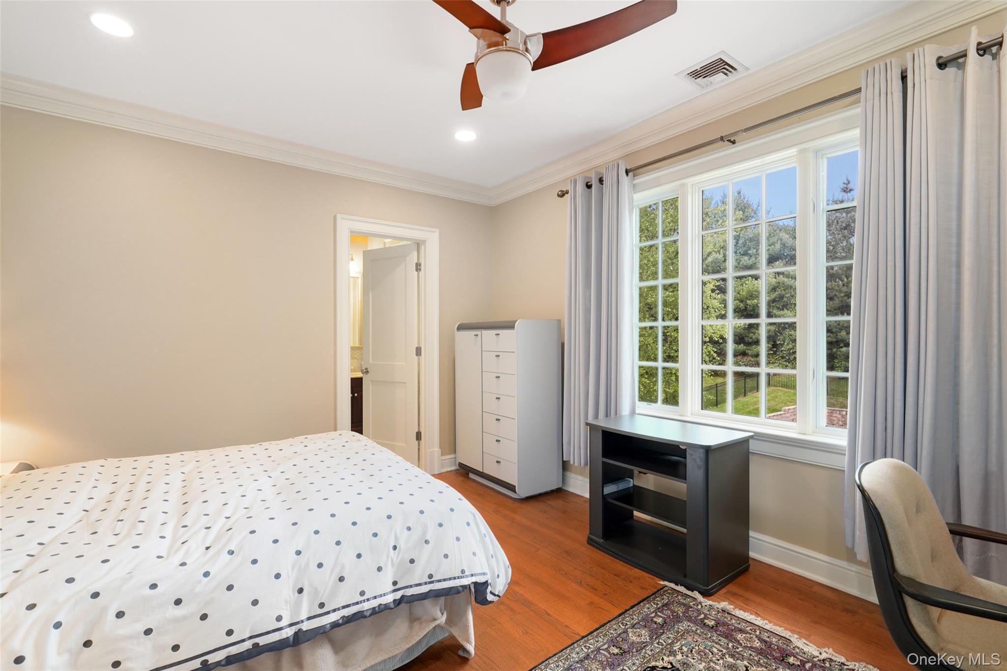 3747 Purchase Street Purchase, NY 10577 - Photo 27 of 48 a bedroom with a bed and wooden floor