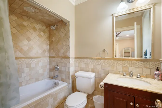 a bathroom with a sink toilet vanity and bathtub