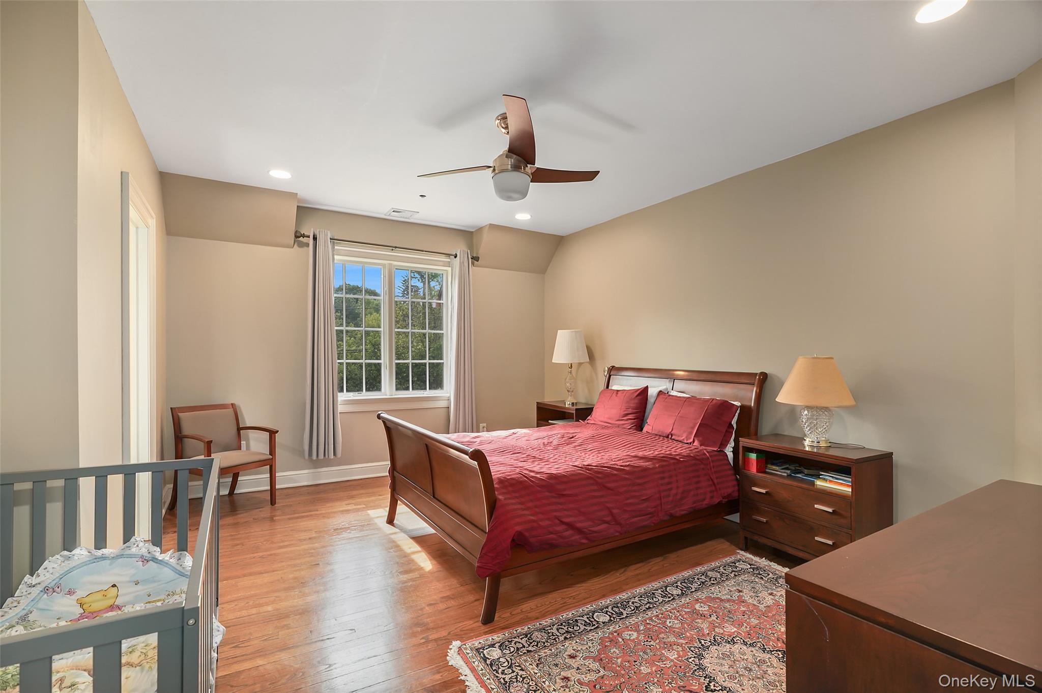 3747 Purchase Street Purchase, NY 10577 - Photo 29 of 48 a bedroom with a bed and wooden floor