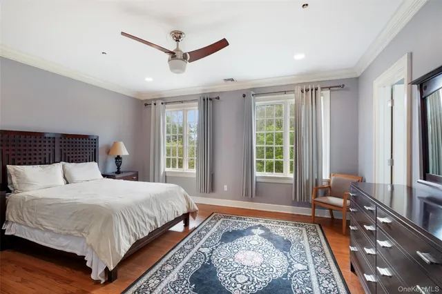 a bedroom with a large bed and a large window