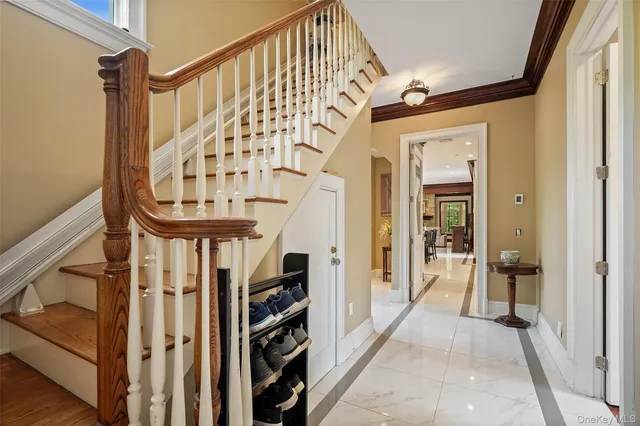 a view of an entryway with wooden floor and stairs