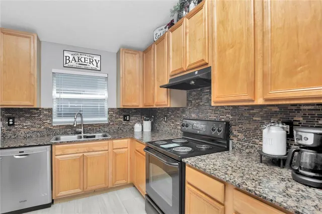 a kitchen with a sink stove and cabinets