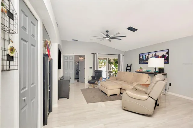 a living room with furniture and a ceiling fan