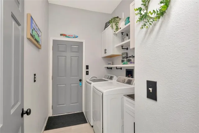 a room with a sink and a refrigerator