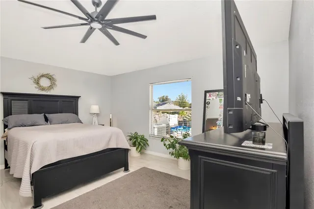 a bedroom with a bed and ceiling fan