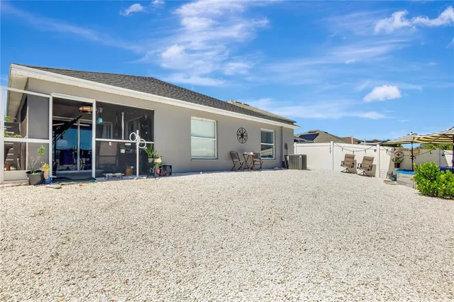 a view of a house with a barbeque and pathway