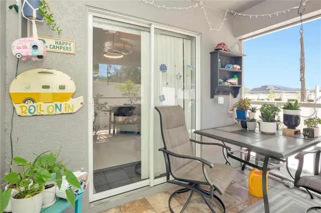 a dining room with furniture and a floor to ceiling window