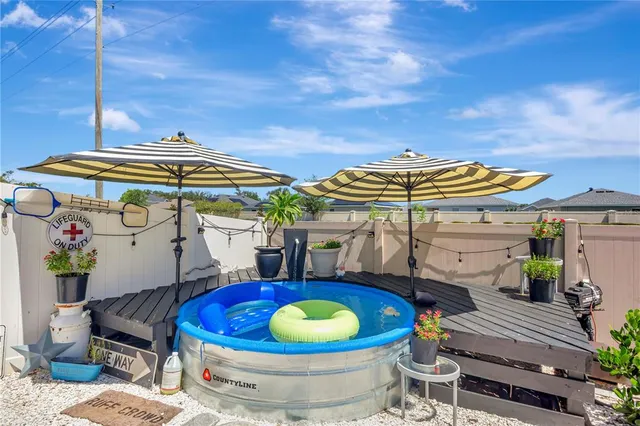 a view of a patio with table and chairs potted plants