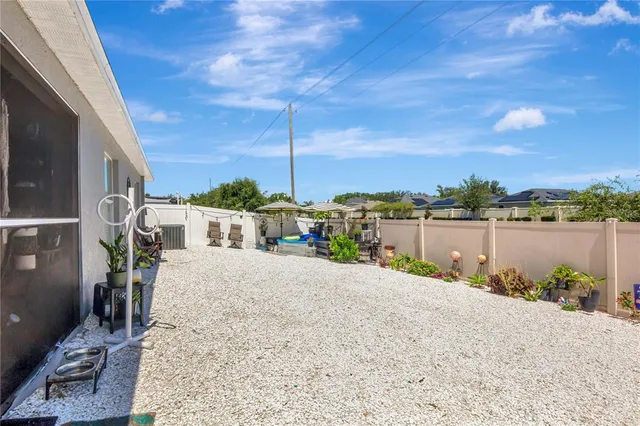a view of a lake with a lawn chairs and wooden fence