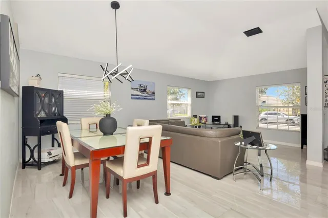 a view of a dining room with furniture and wooden floor