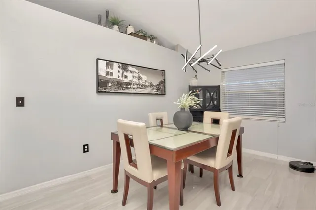 a view of a dining room with furniture and a chandelier