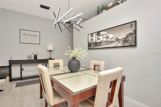 a dining room with furniture and wooden floor